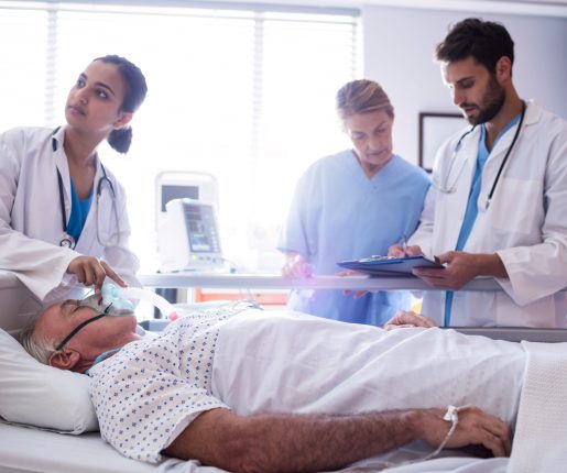 Female doctor putting oxygen mask on patient face in the hospital